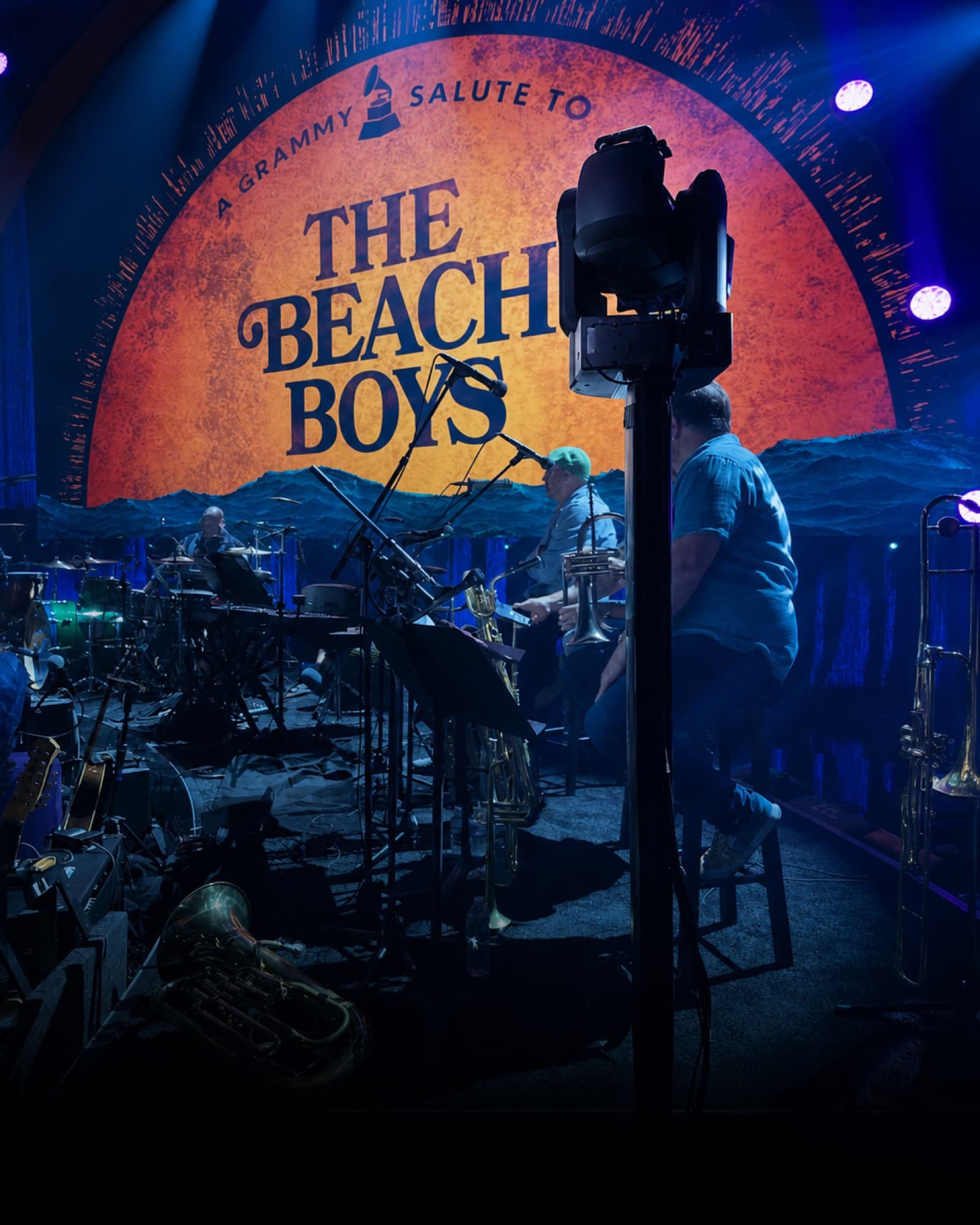 Fluid Pictures AutoPod raising a PTZ camera beside the orchestra on a blue-lit Beach Boys tribute stage