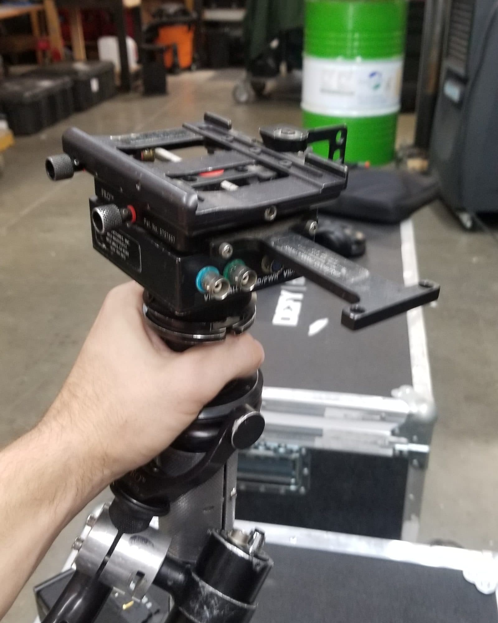 Machined camera mounting plate held in hand in the Fluid Pictures machine shop