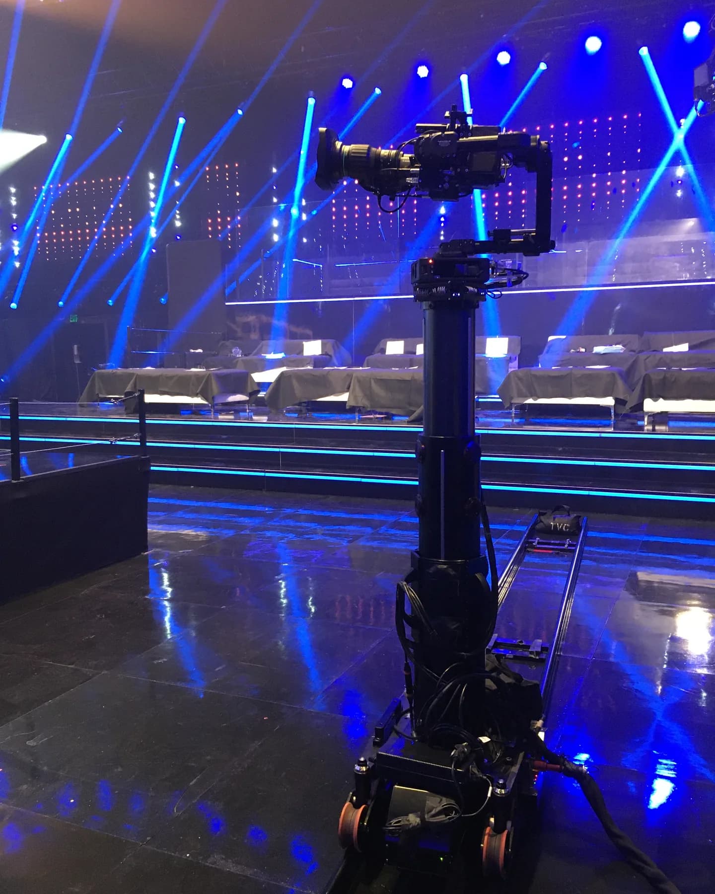 Furio robotic dolly on track under blue stage light beams