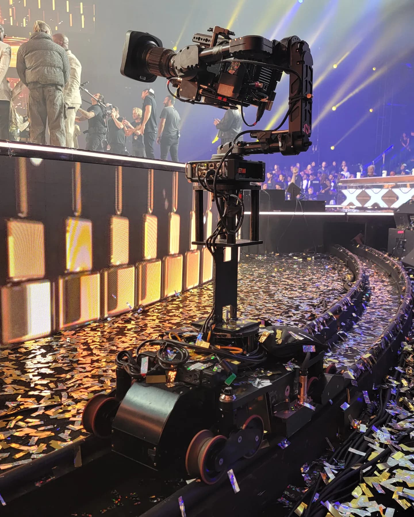 Furio robotic dolly with a stabilized head on curved track through confetti at the edge of an awards stage