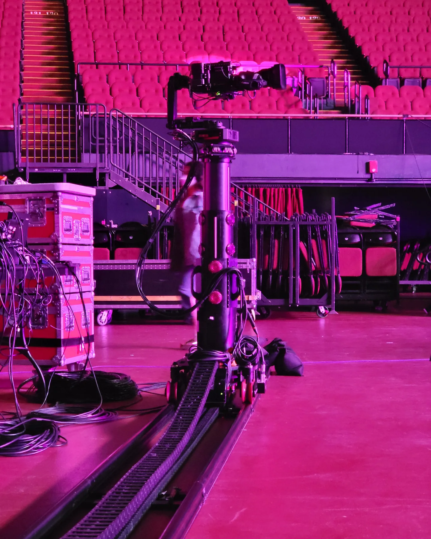 Furio robotic dolly on floor track in a pink-lit arena
