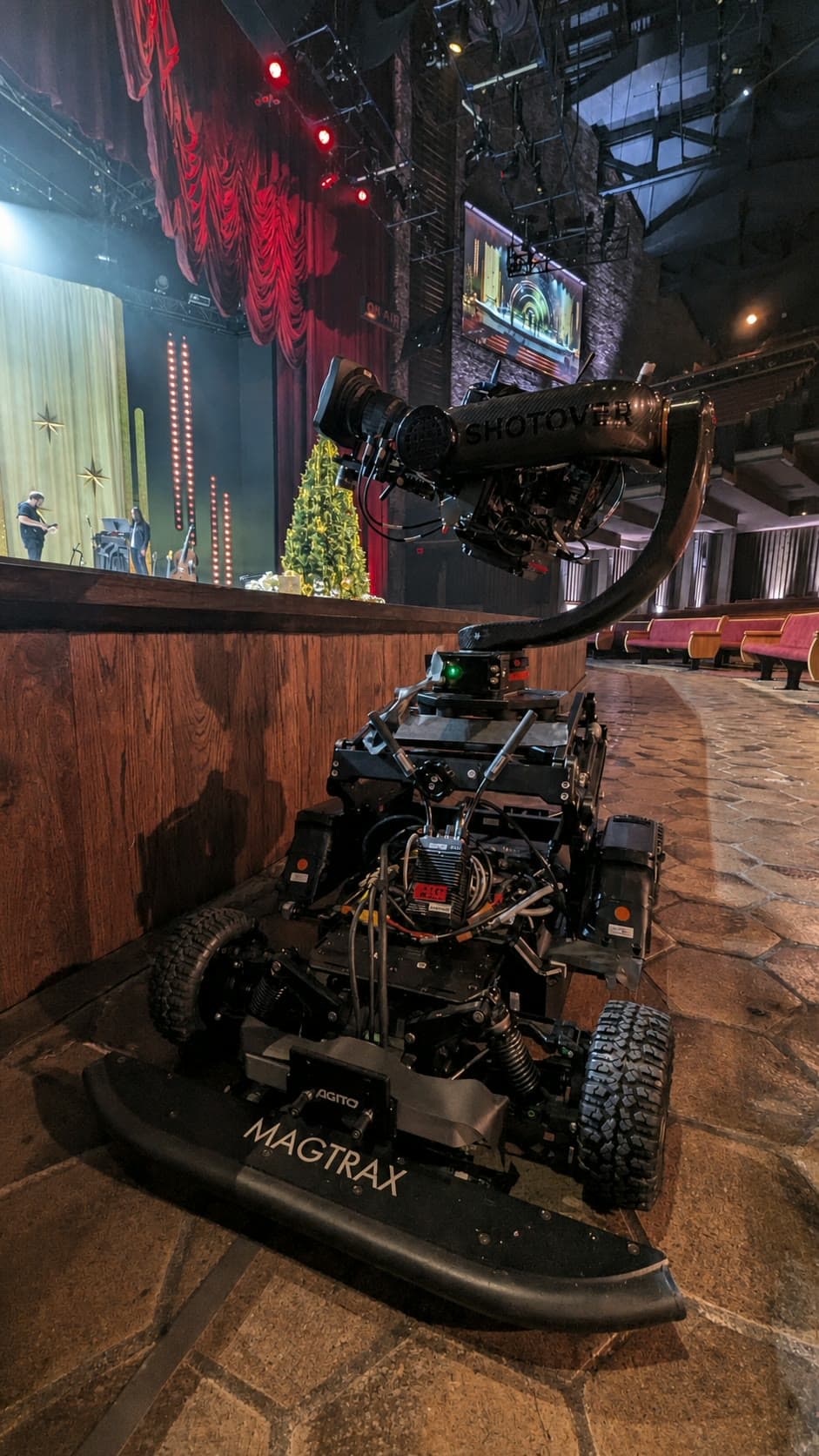 Fluid Pictures Agito MagTrax robotic dolly carrying a Shotover stabilized camera head in a theater