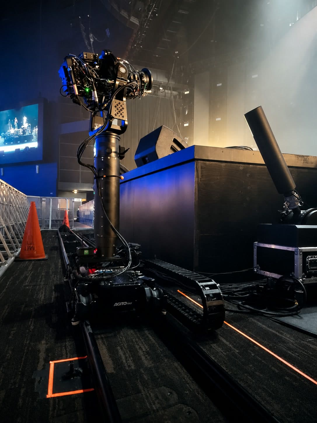Fluid Pictures Agito Trax robotic dolly operating on rail beside a concert stage