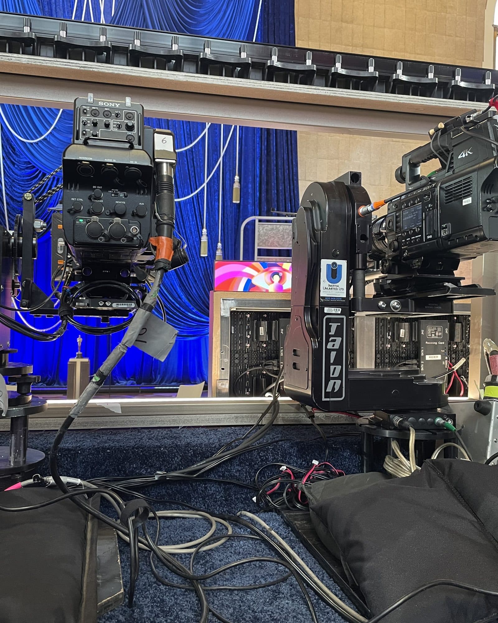 Two Talon remote heads carrying broadcast cameras on a blue-lit awards stage