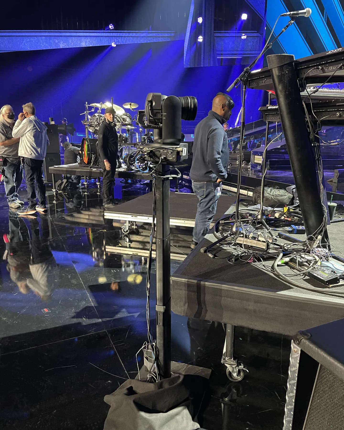Towercam Mini with a robotic camera set beside the drum riser on a concert stage