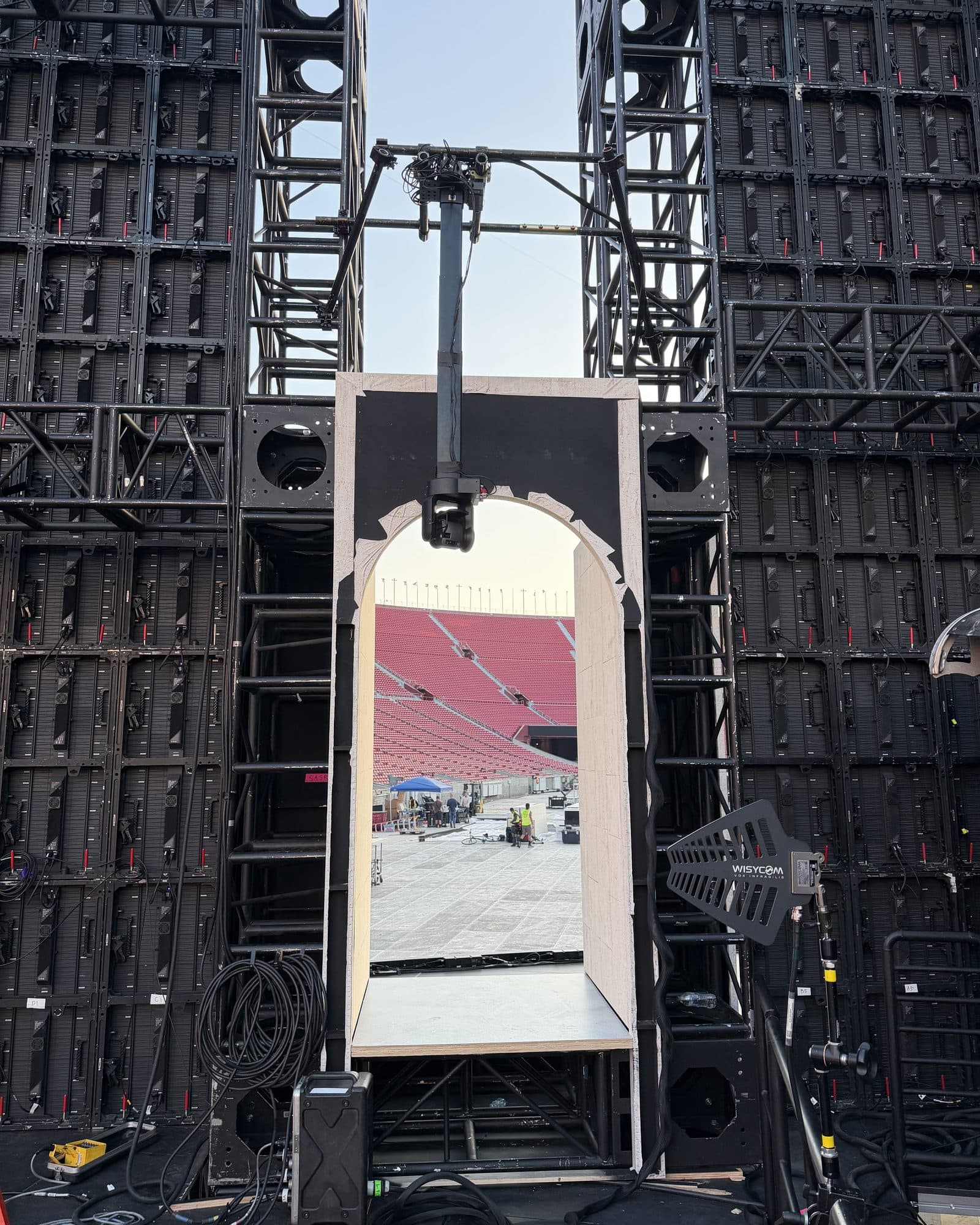 Towercam Mini set between stadium LED walls, carrying a camera through an arch in the scenery