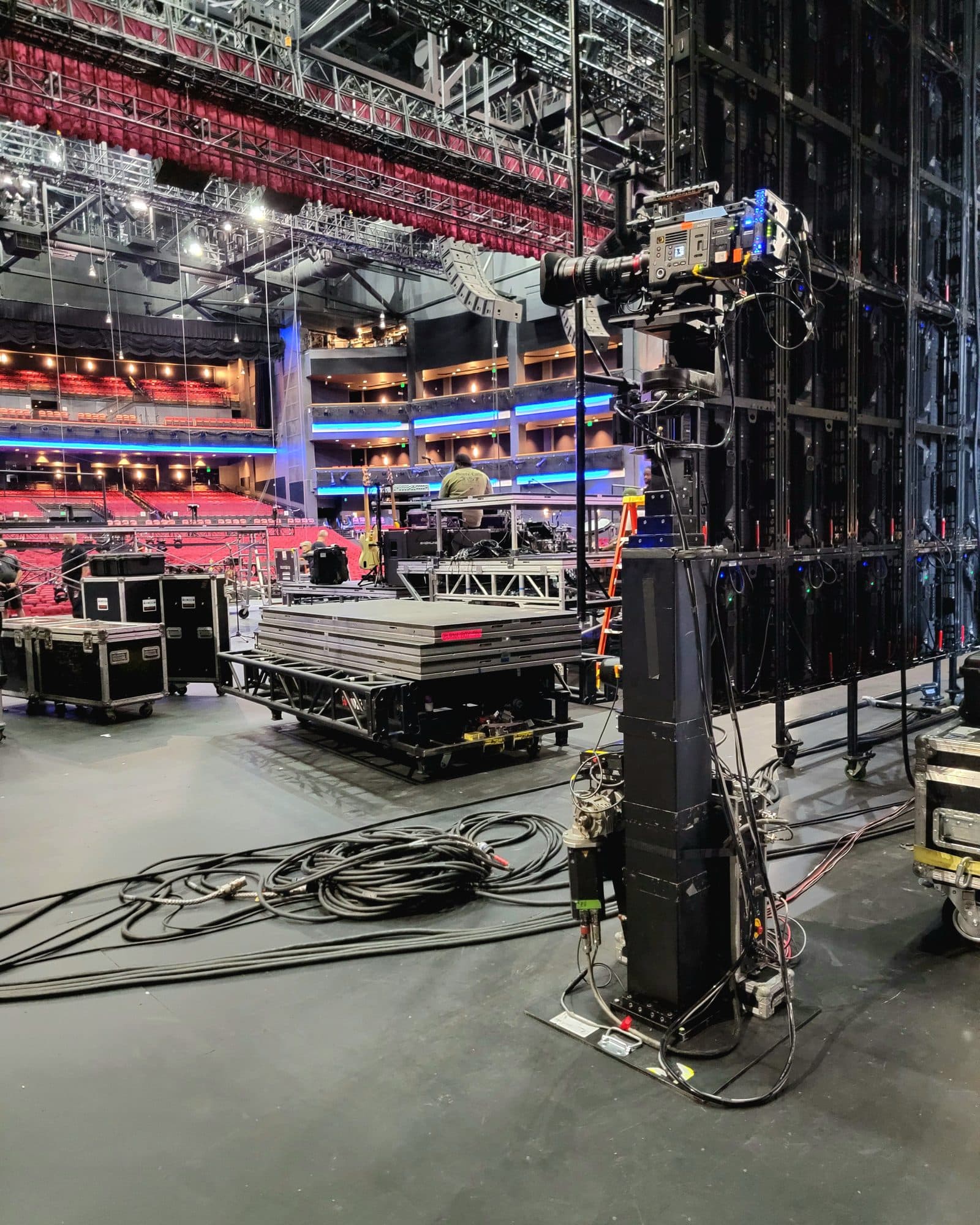 MAT Towercam Standard standing at full height in an arena during setup, with the seating empty