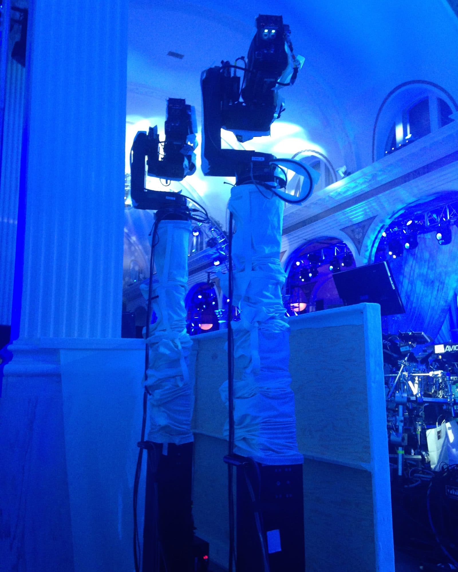 Two MAT Towercam Standard columns wrapped to match the set in a blue-lit venue