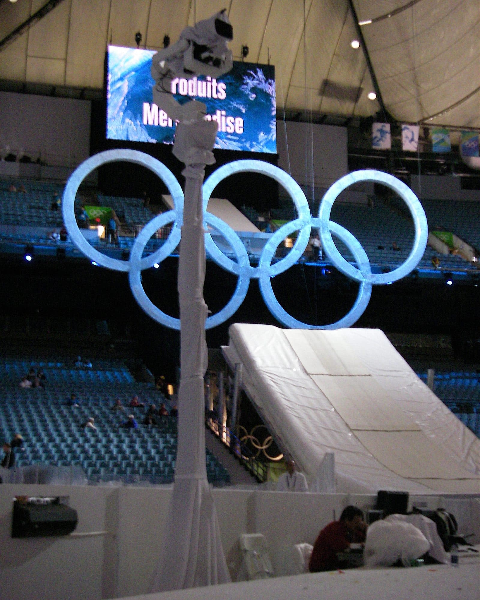 MAT Towercam Standard carrying a camera beside the illuminated Olympic rings in a stadium