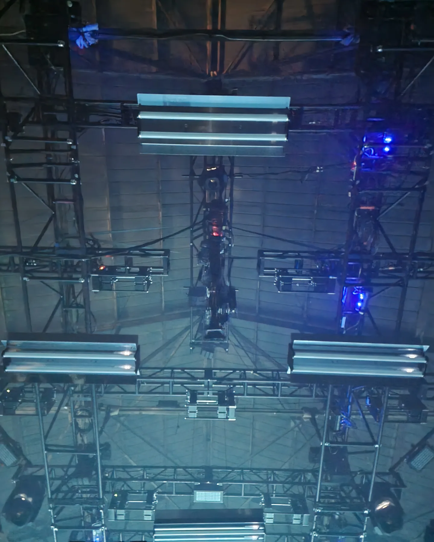 Twin Peek rigged in the overhead grid between lighting bars, looking straight up from the stage floor