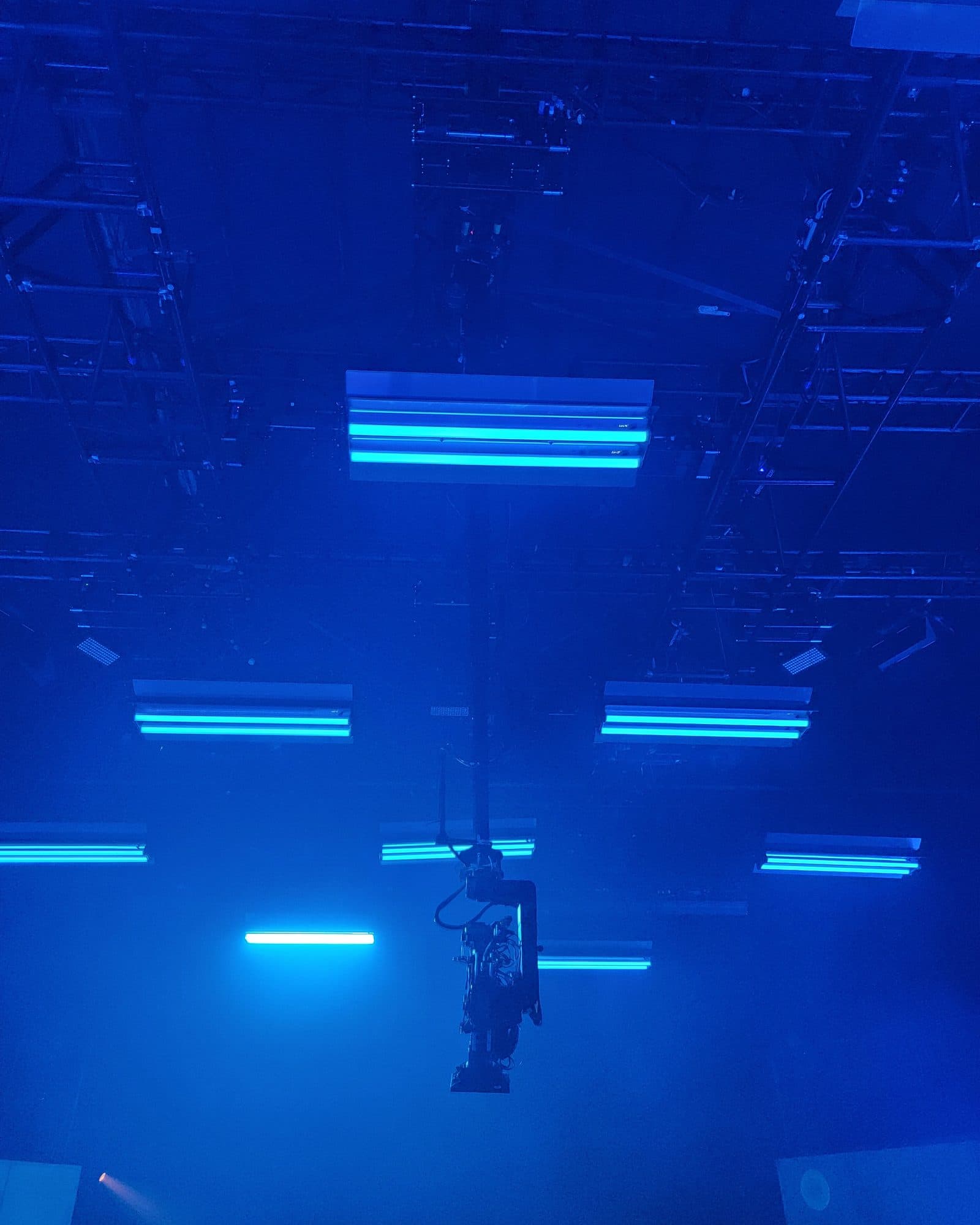 MAT Twin Peek towercam raised in a blue-lit studio below the lighting grid