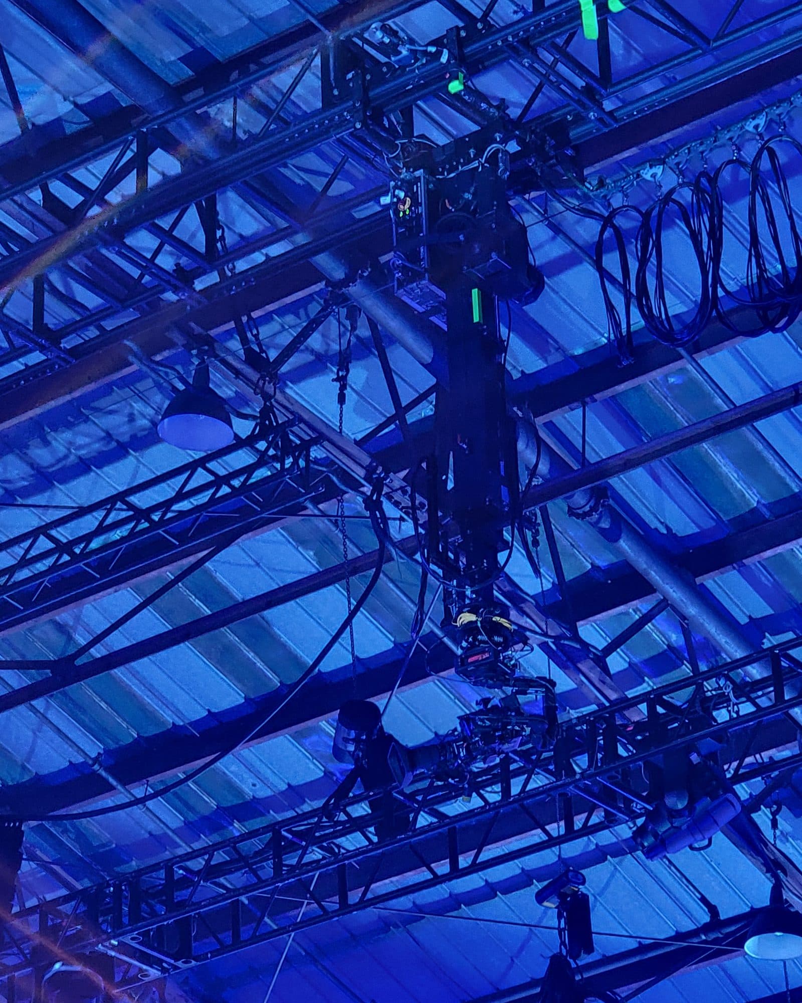 MAT Twin Peek towercam reaching up into a blue-lit lighting truss