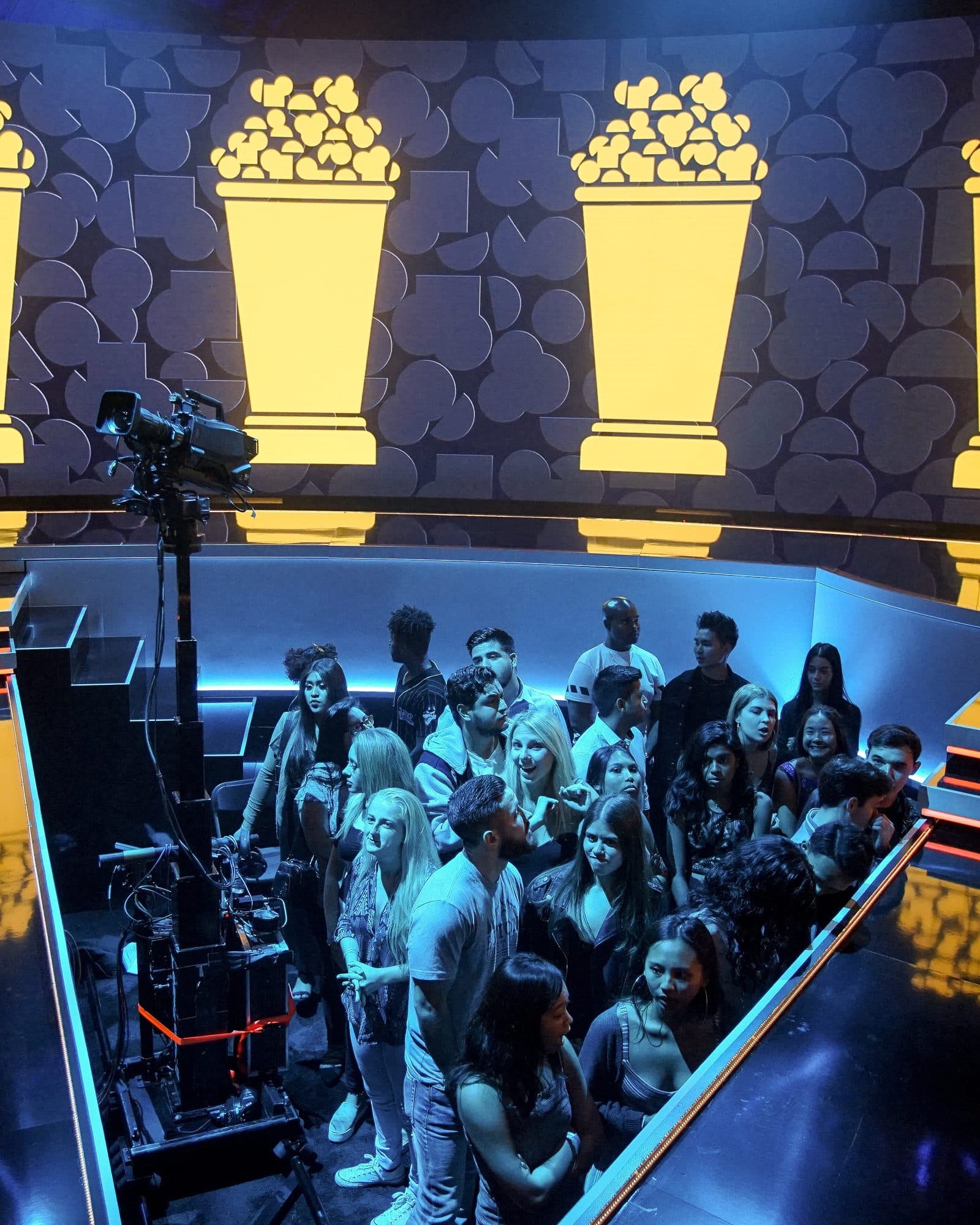 MAT Towercam XS+ carrying a camera at the edge of an audience pit on a lit awards set