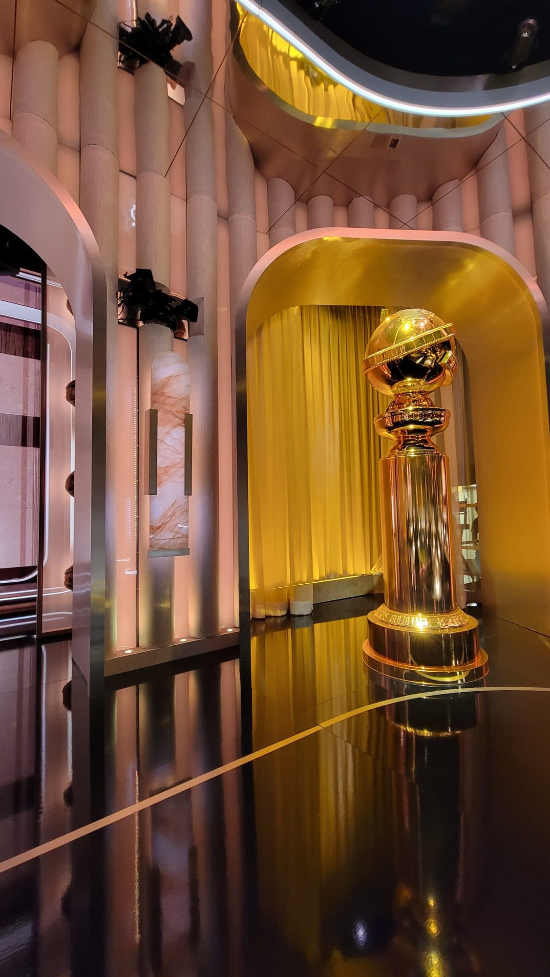 Stanton Mini remote head mounted high on the set wall beside the Golden Globe statue