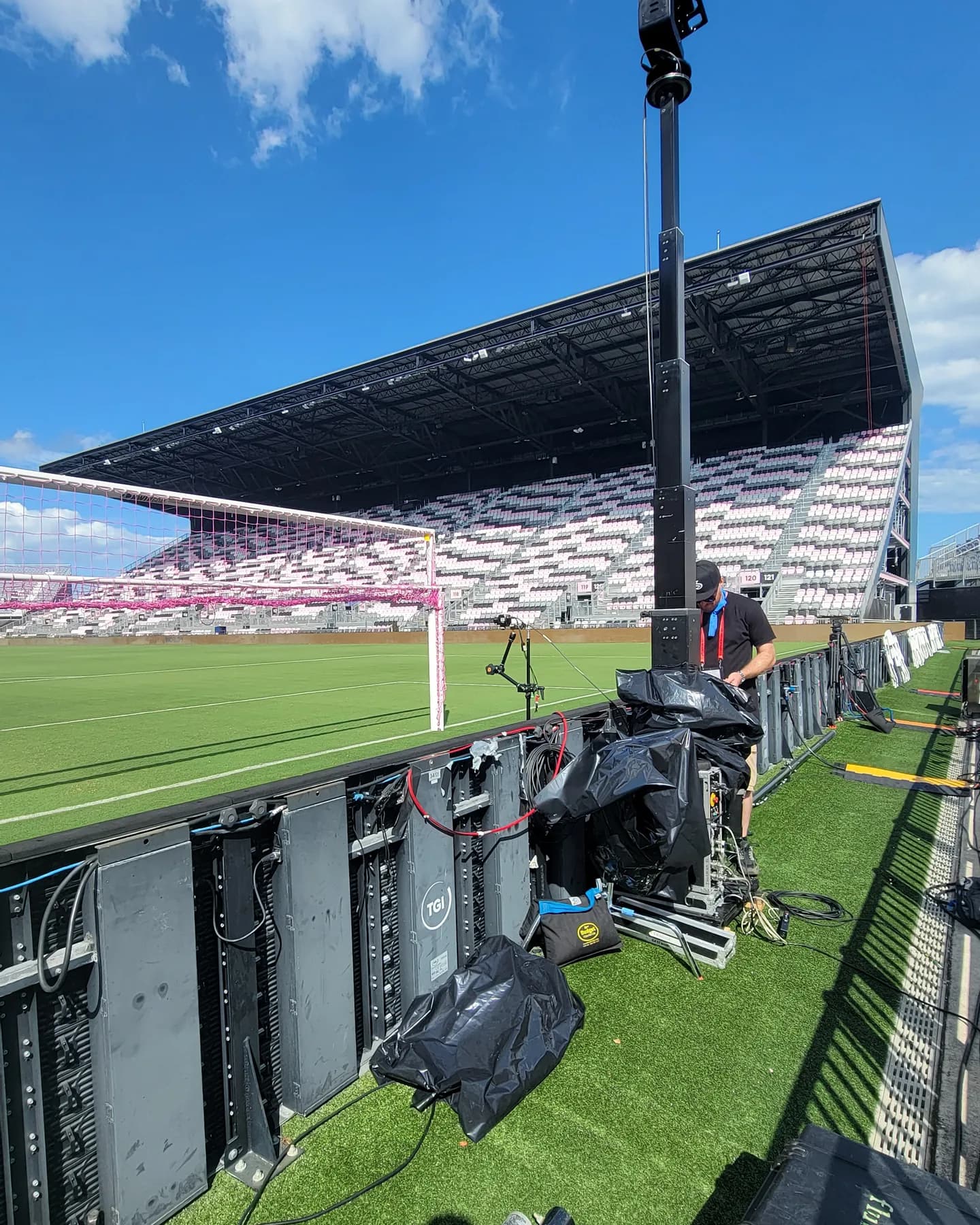 Standard Towercam raised high on the sideline of a soccer stadium under a blue sky